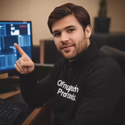 a man with a black sweatshirt is pointing to the screen