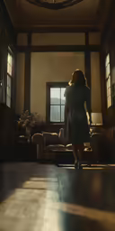 the woman stands near a large window in the sun