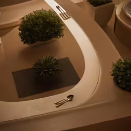 some bushes and silverware set in a table