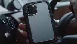 a person holding a black and gray case on their phone