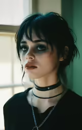 a close up of a person wearing choker and necklace
