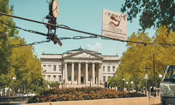 a building on a city street with cars parked around