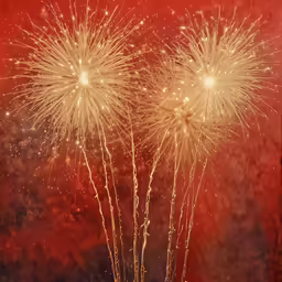 some bright yellow fireworks exploding into the night sky