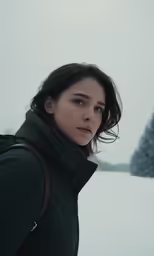 a person standing in the snow looking off into the distance