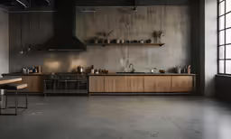 an industrial kitchen with a gray cement wall