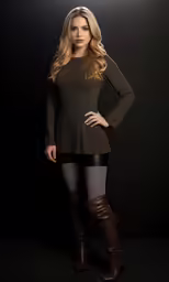 the beautiful young woman is posing in leather boots