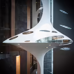 this futuristic building features a spiral staircase and large windows
