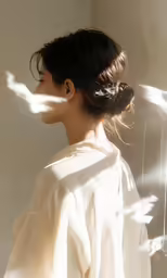 woman in white dress in the sunlight casting a shadow