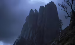 the dark sky is covering a bunch of mountains
