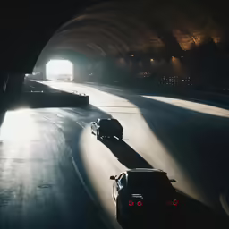 a car driving into the tunnel on a road
