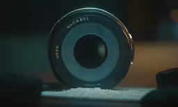 a close up of a camera lens on some white material