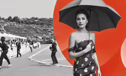 a black and white photo of a woman holding an umbrella