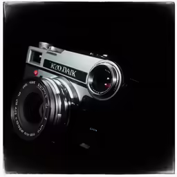 a old, black and white camera that reads kodak