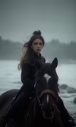 a woman is riding a horse on the beach
