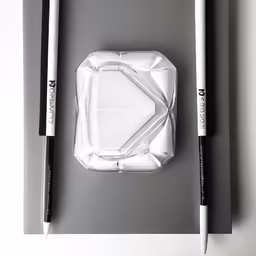 two black and white pens are laying on top of the tray