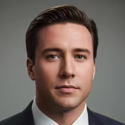 a man in a suit is looking into the camera