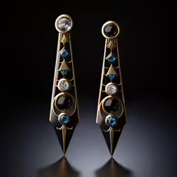 two very long gold and stone earrings