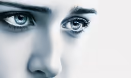 woman with beautiful make - up and large eyes staring to camera