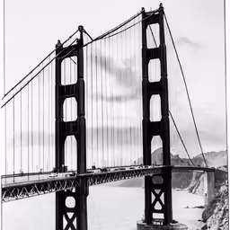 a bridge over the water with a very tall tower