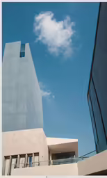 an unusual building stands in front of a cloudless sky