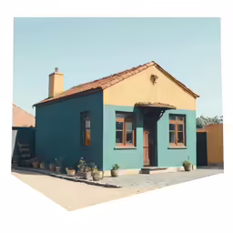 a blue house with brown trim and some pots of plants in front of it
