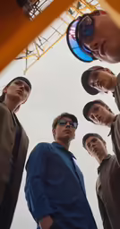 an image of four men taking a picture