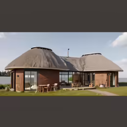 a house with an thatched roof in front of a body of water