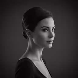 a woman wearing black clothing posing for a portrait