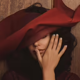a beautiful woman with a red hat on her head