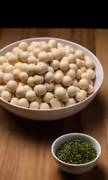 two white bowls filled with green peas and peas
