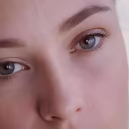 a young woman with a brown eye is shown in close up