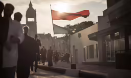 many people walking down the street with red flags