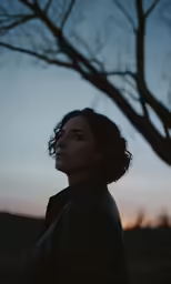 a young woman in the evening looking away