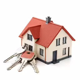 a house is shown with three keys laying next to it