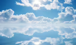 the sky above some water is filled with fluffy clouds