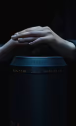 a person is holding onto a large black trash can