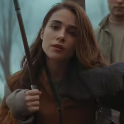 a person holding a walking stick on a rainy day