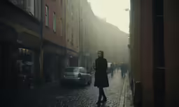 a woman is walking down the middle of an alley