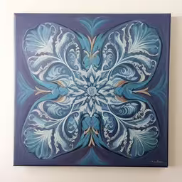 a blue floral painting on a white wall,painting on wall hanging in a room