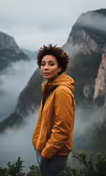 a young person is standing in the mountains