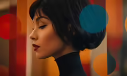 an artistic woman with black hair and blue circles above her head