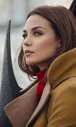a woman sitting in a car holding onto her umbrella
