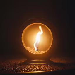 the small candle in the candle light has the bright flame from it