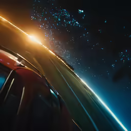 the night sky and some lights are shining bright over an open highway