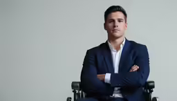 a man in a suit sitting on top of a chair