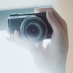 the person is holding a camera in their hands