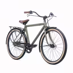 a green and tan bicycle parked on a white floor