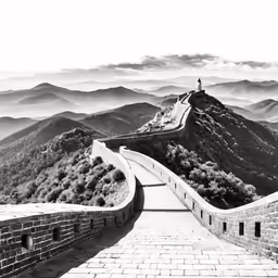 black and white image of a great wall in the mountains