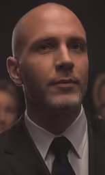 a bald man in a suit and tie