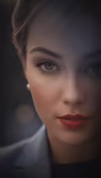a woman with bright makeup and a blazer on